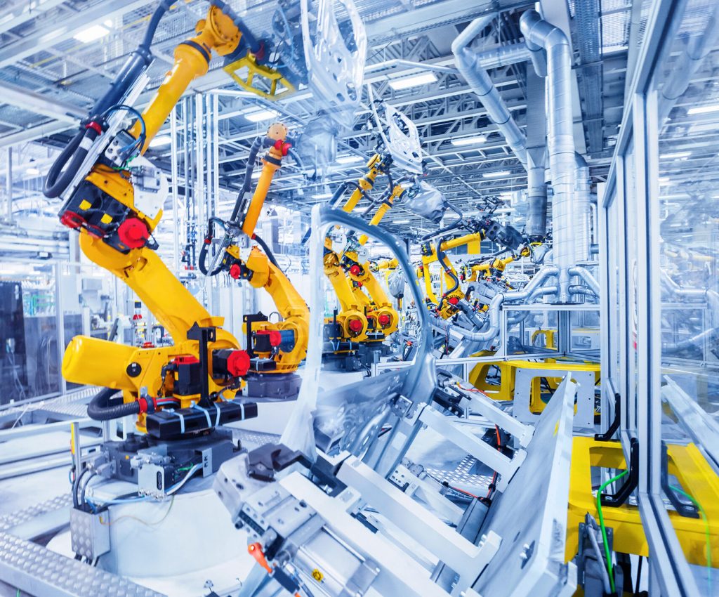 robotic arms in a car plant