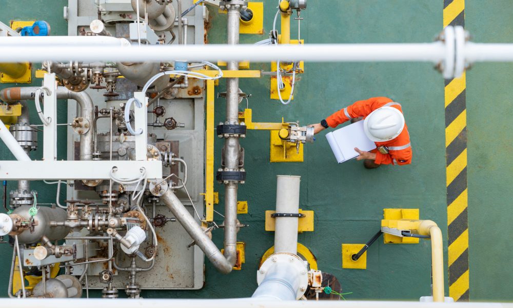 Mechanical operator checking centrifugal pump condition for daily checking oil pump system to maintain reliability of oil and gas production process.